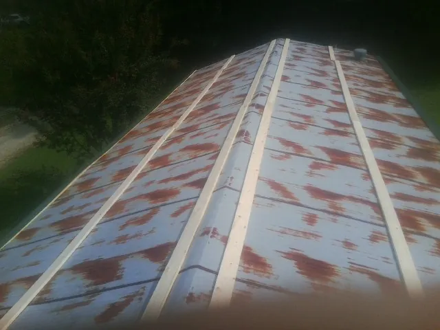 Rusted metal roof panels with new wood purlins before replacement — Storm Damage Roof Repair in Kincaid by Roofing Brothers